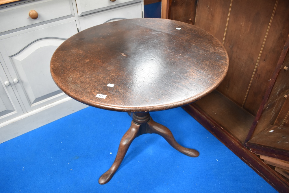 A Victorian pedestal table having circular snap top on turned column and triple splay legs