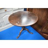 A Victorian pedestal table having circular snap top on turned column and triple splay legs