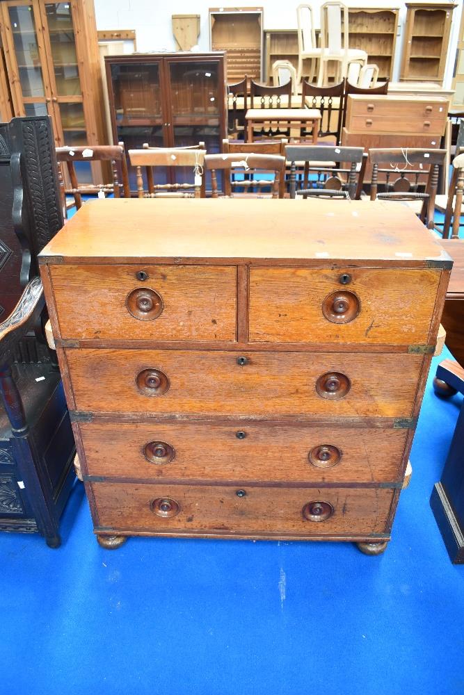 A 19th Century campaign chest of two over three drawers having recessed handles