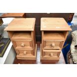 A pair of traditional pine bedside cabinets