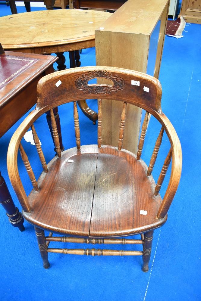 A Victorian oak spindle back tub chair