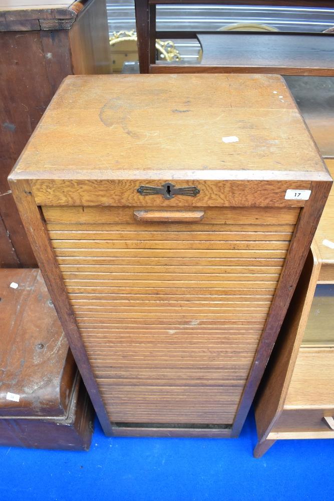 An early 20th Century golden oak tambour front office cabinet