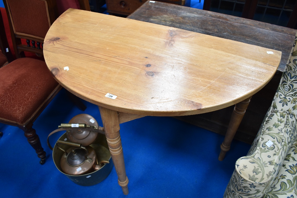 A natural pine demi lune hall table on turned legs, width approx. 102cm