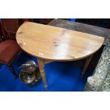 A natural pine demi lune hall table on turned legs, width approx. 102cm