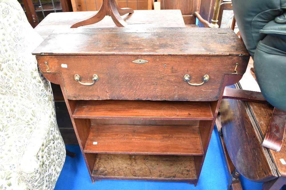 A 19th Century oak bookshelf with faux drawer to top with storage under lift lid, possibly