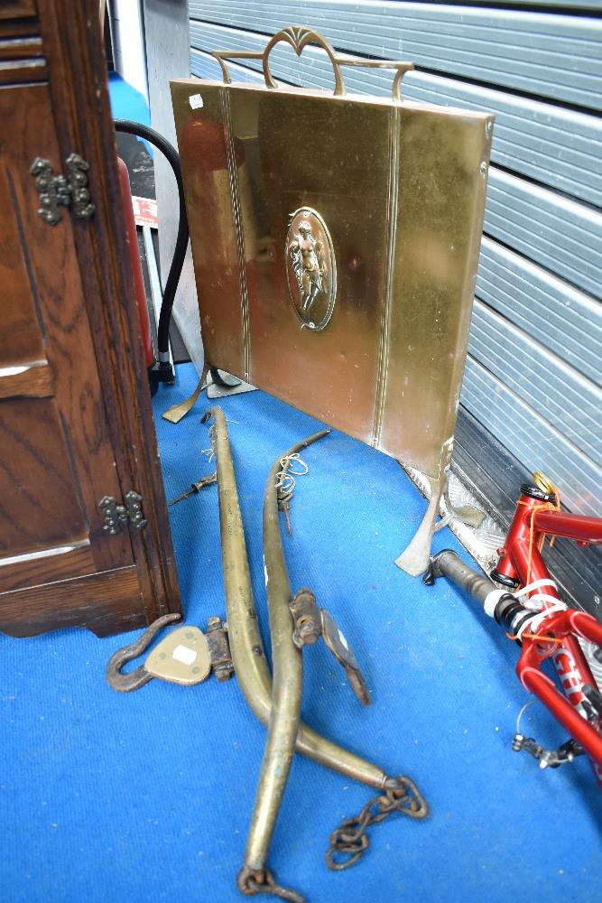 A pair of vintage brass horse hames and an Art Nouveau style brass and copper fire screen