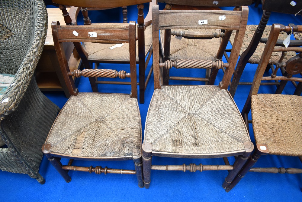 Two 19th Century rush seated chairs having twist rail back