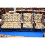 A late 19th or early 20th Century three piece lounge suite having oak twist frae, bergere cane sides