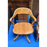 An early 20th Century oak swivel office chair