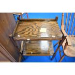 An early 20th Century oak tea trolley having twist frame