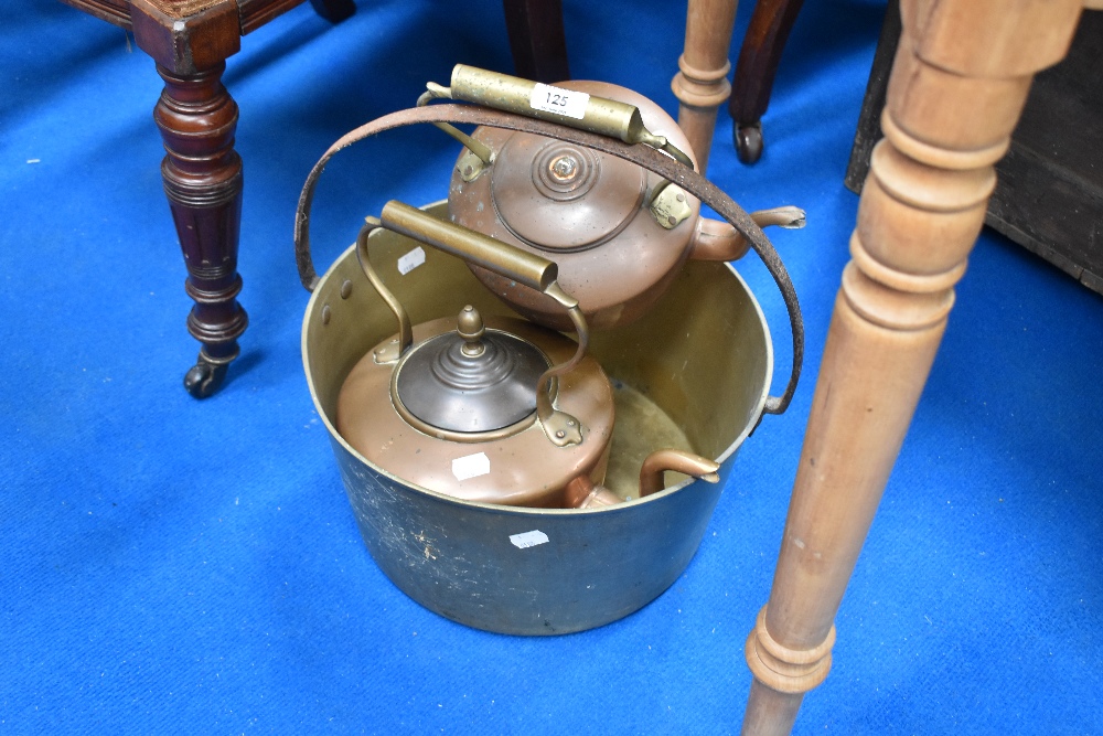 A traditional brass jam pan and two copper kettles