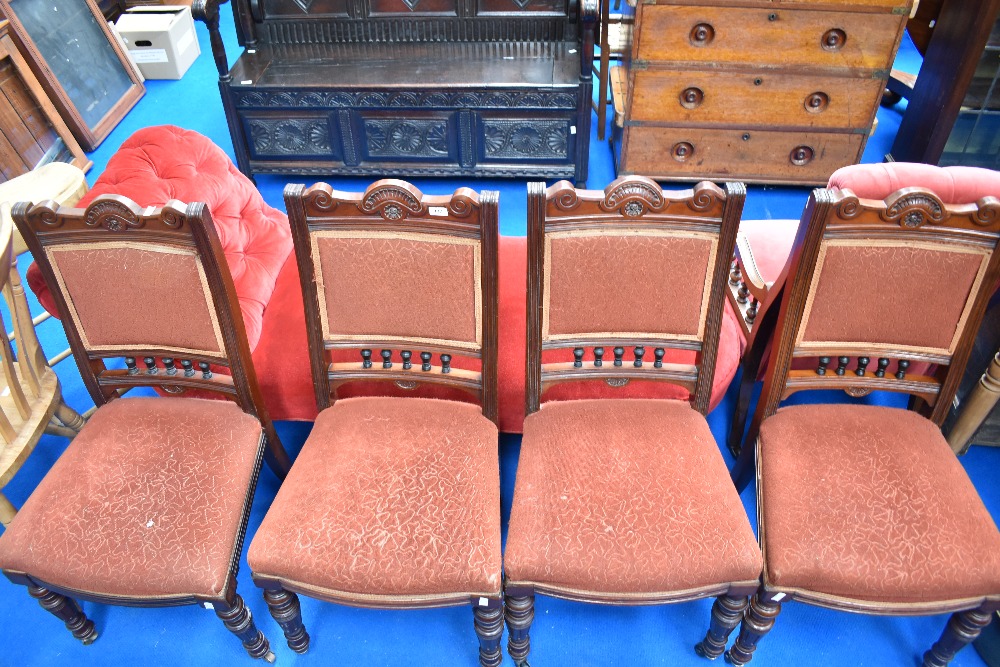 A set of four Victorian mahogany dining chairs having overstuffed backs and seats