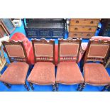 A set of four Victorian mahogany dining chairs having overstuffed backs and seats