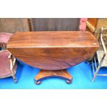 A William IV mahogany drop leaf dining table on typical platform base with bun feet