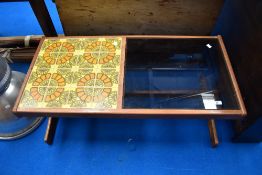 A vintage teak coffee table having tiled and smoked glass top