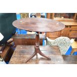 A 19th Century mahogany pedestal occasional table having oval top, turned column and triple splay