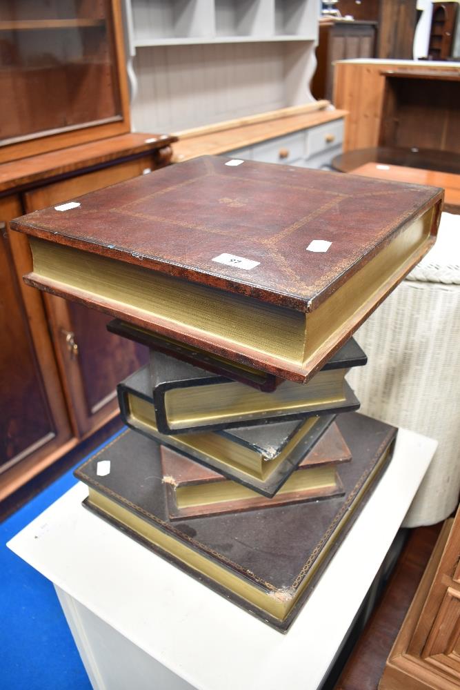 A modern occasional side table modelled as pile of books