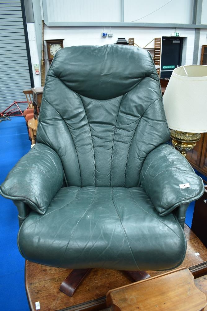 A green leather easy chair , Stressless style