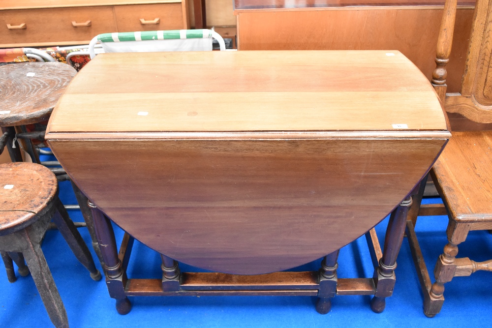 An early 20th century gateleg dining table having turned frame