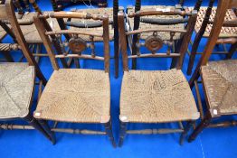 A pair of 19th Century chairs having seagrass seats with turned decoration to backs
