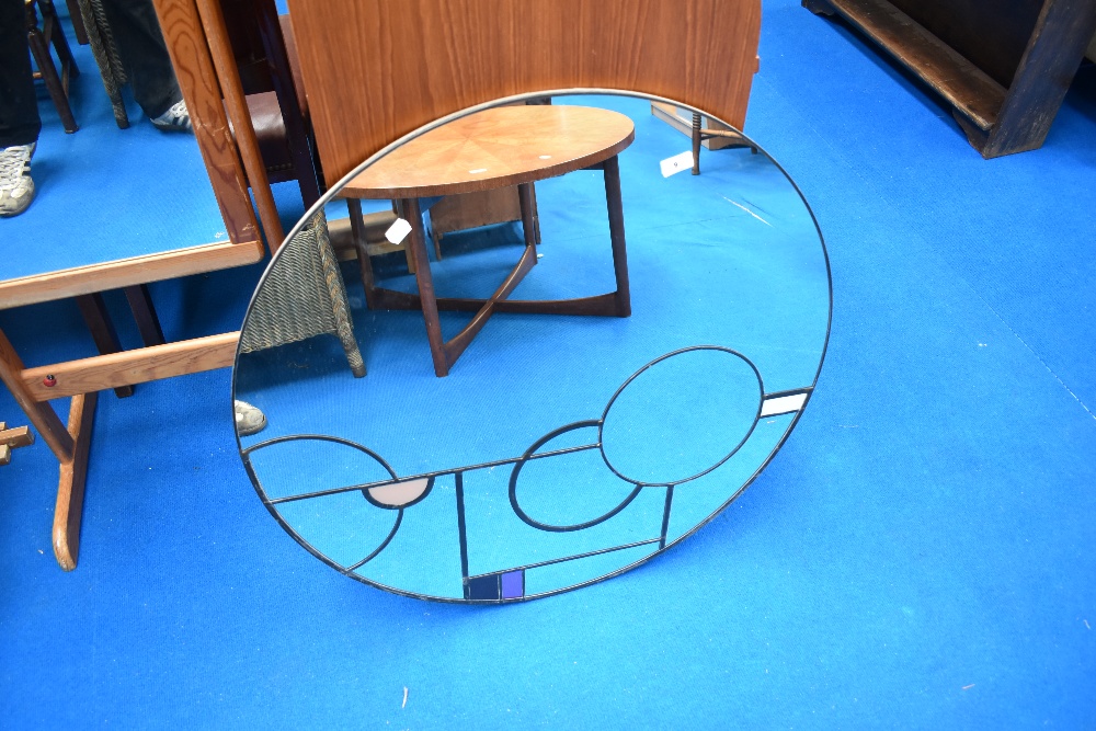 A modern circular wall mirror of large proportions in the Deco style