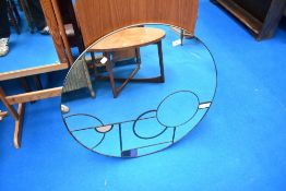 A modern circular wall mirror of large proportions in the Deco style