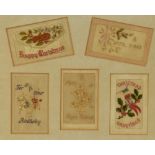 A framed collection of early 20th Century silk embroidered greetings cards, framed, mounted, and