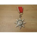 A China, Republic, Order of the Golden Grain, breast badge, in silver, silver-gilt and enamels,