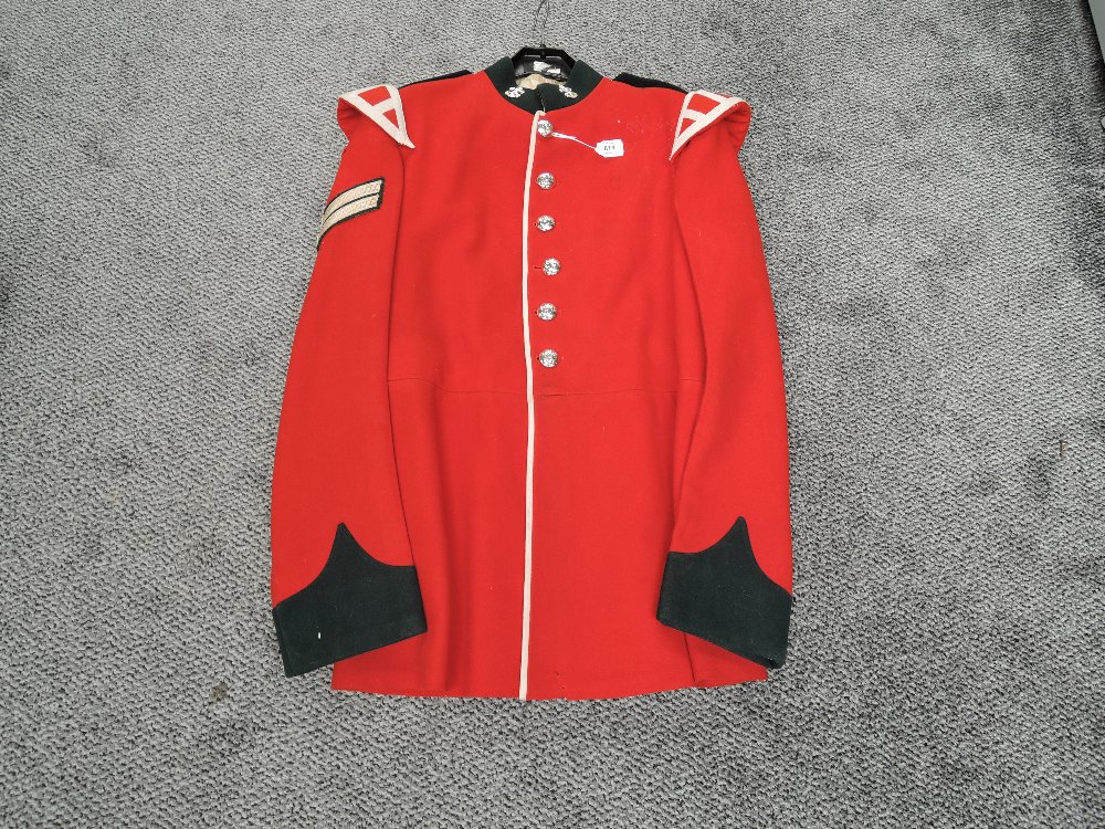 A Red Corporal Bandsman Jacket, with 6 buttons to front, two collar badges, no size stated,