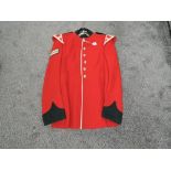 A Red Corporal Bandsman Jacket, with 6 buttons to front, two collar badges, no size stated,