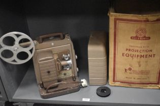 A vintage Bell & Howell auto load 8mm film projector with original box.