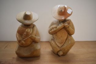 Two hand made Mexican figural ornaments of mother and child and musician, the largest measures