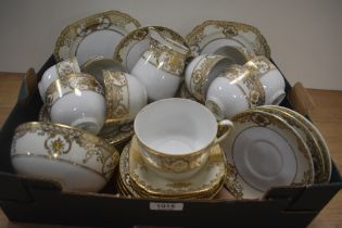 A selection of Noritake table ware, having white ground with gilt relief floral baskets and motifs.