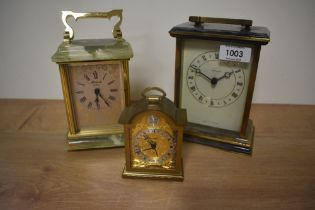 Two onyx and brass carriage clocks and a smaller similar alarm clock.