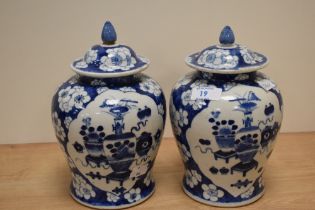 Two 19th century Chinese blue and white pottery lidded ginger jars, with plant, vase cracked ice and