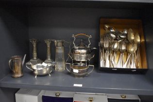 A collection of vintage flatware, a pair of silver plated candlesticks of column form, a small