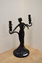 A reproduction cast and patinated metal Art Nouveau design twin branch candleabra, with central