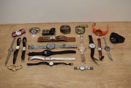 An assorted collection of ladies and gents fashion watches, including an RNIB digital wristwatch