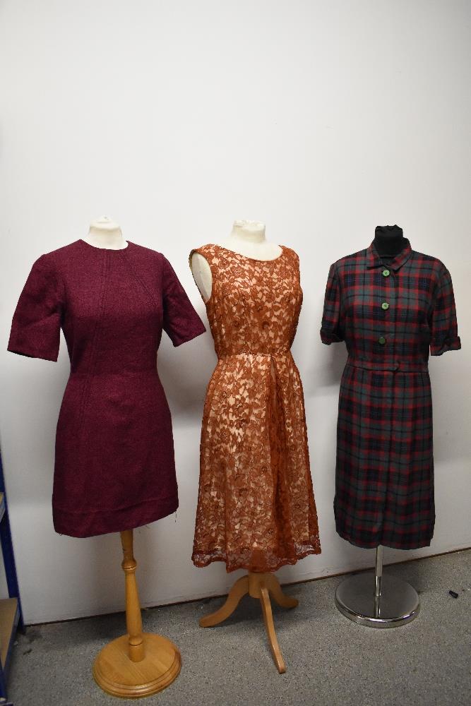 Three vintage 1950s to 1960s dresses, including plaid cotton in a larger size, with belt.