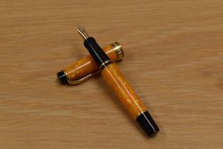 A boxed with papers Aurora Minima twist fill fountain pen in orange marble with gold trim having 18K