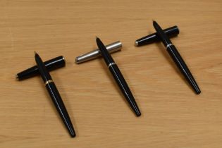 Three Parker 45 fountain pens one black with gold trim, one black with chrome trim and one black