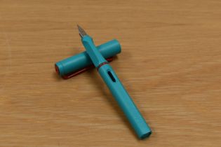 A Lamy Safari Special Edition cartridge fill fountain pen in aquamarine with red trim having M