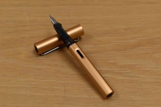 A Lamy Al-Star cartridge fill fountain pen in bronze with chrome trim having M Lamy nib.