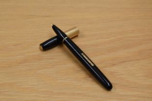 A Waterman Taperite lever fill fountain pen in black having 14K hooded nib. Pitting to cap and