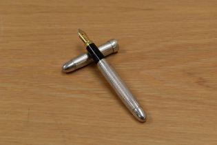 An unmarked white metal cartridge fountain pen having Iridium Point Germany nib. Cap inscribed.