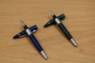 Two unnamed cartridge fill fountain pens one blue one green having Iridium Point Germany nibs.