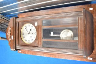 An early 20th Century oak cased wall clock having silvered dial