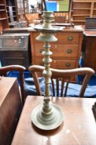 An eastern brass candlestick/smokers stand, height approx 64cm.