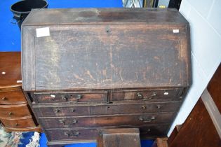 A period oak bureau in distressed condition, width approx 102cm.