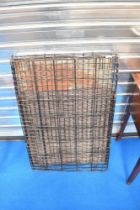 A medium to large sized dog crate, bottom tray approx 65cm by 90cm.